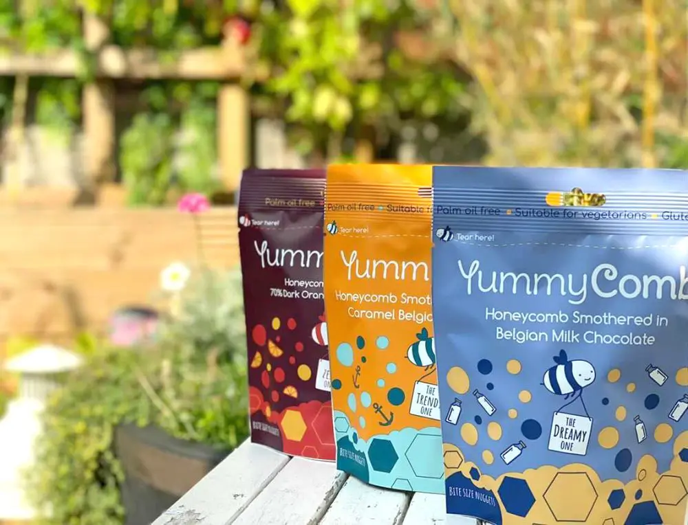 Yummycomb pouch bag selection in a Yorkshire garden. Premium Milk, Sea Salted Caramel and 70% Dark Chocolate Orange Belgian chocolate.